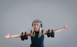 A picture of Diane Knoll, OTR/L wearing headphones for the therapeutic listening program. Therapeutic Listening can help decrease auditory defensiveness and improve  the ability to discriminate sounds.